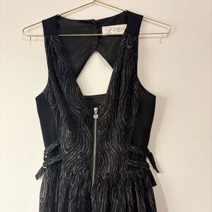 Lipsy Black sleeveless dress with a cool pattern, zipper, hooks and buttons.